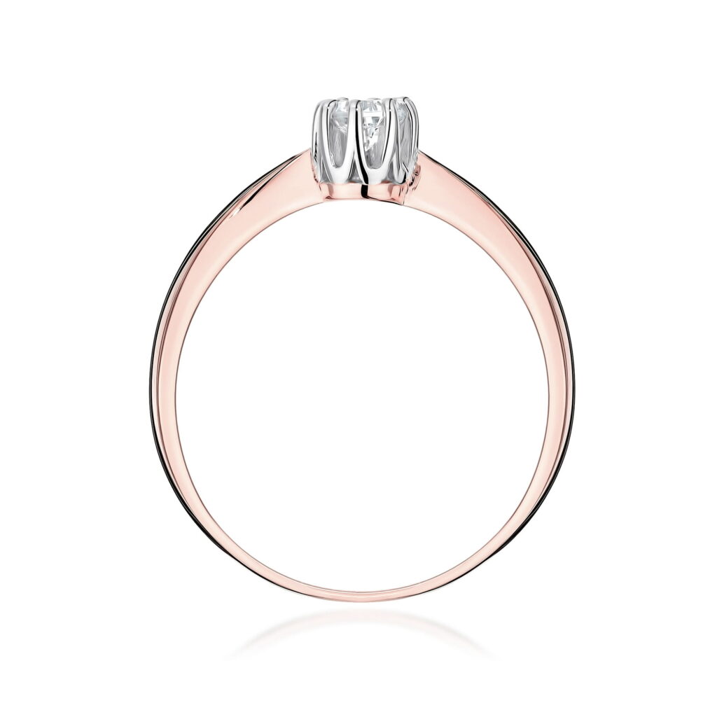 Złoty pierścionek z diamentem, o delikatnym, eleganckim designie.