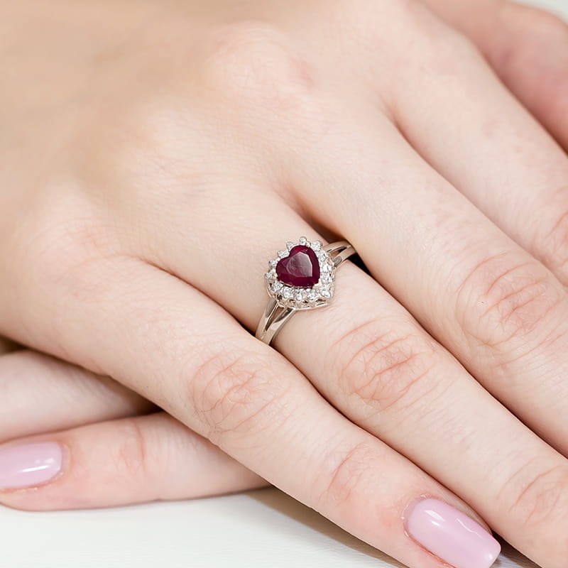 W0310.B3.RUR.01_4 Pierścionek z sercowym rubinem otoczonym diamentami na palcu z delikatnym manicure.