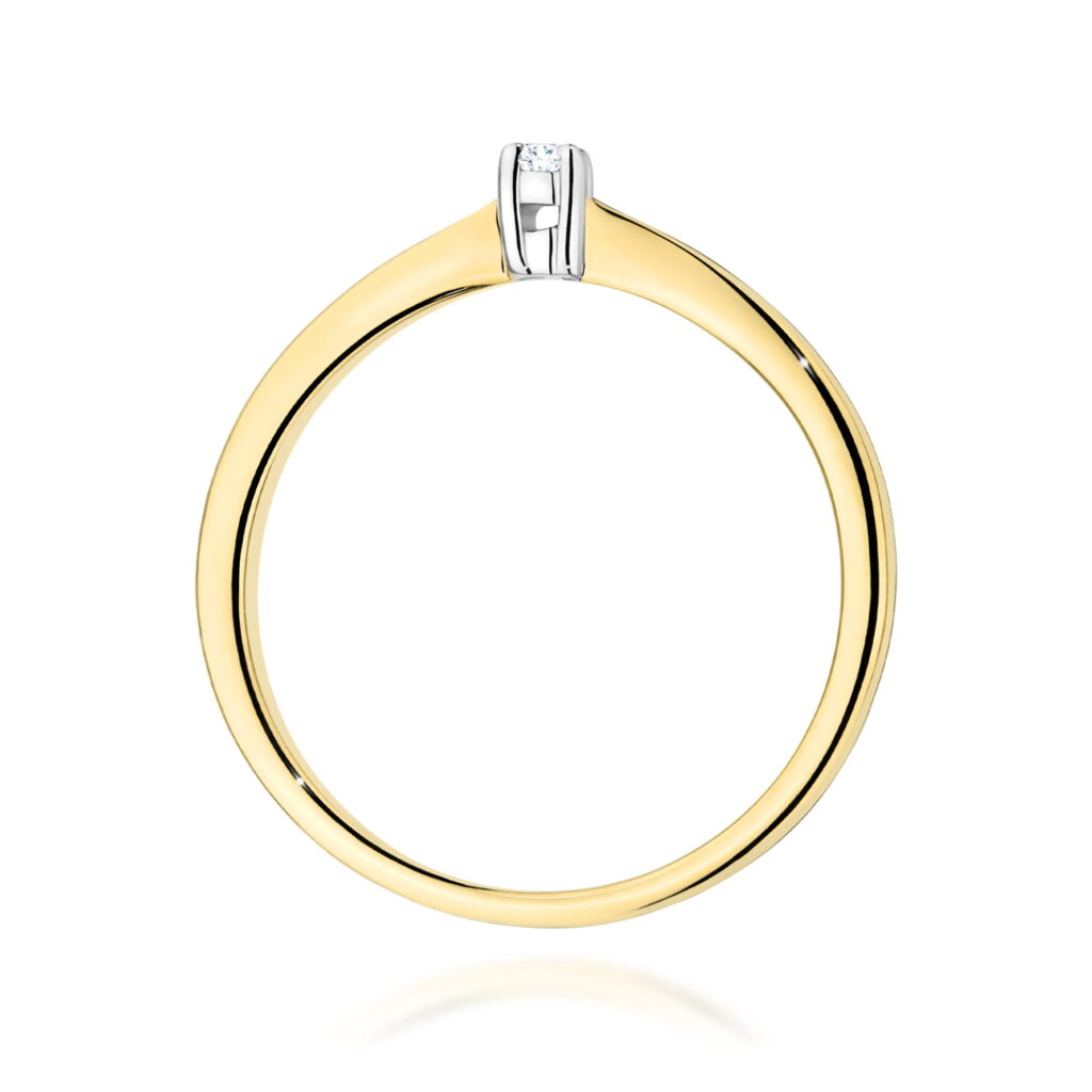 Złoty pierścionek z diamentem, o minimalistycznym designie i eleganckim wykończeniu.